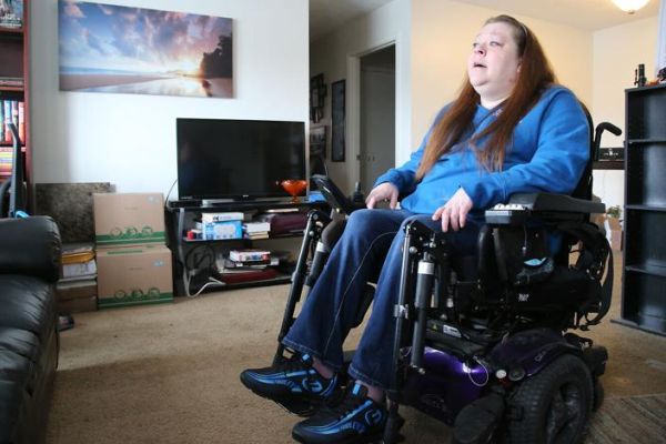 A white woman in a wheelchair