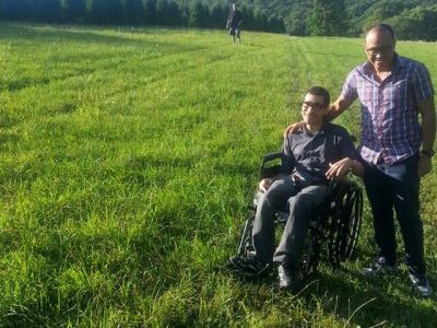 2 smiling Hispanic men wearing glasses
